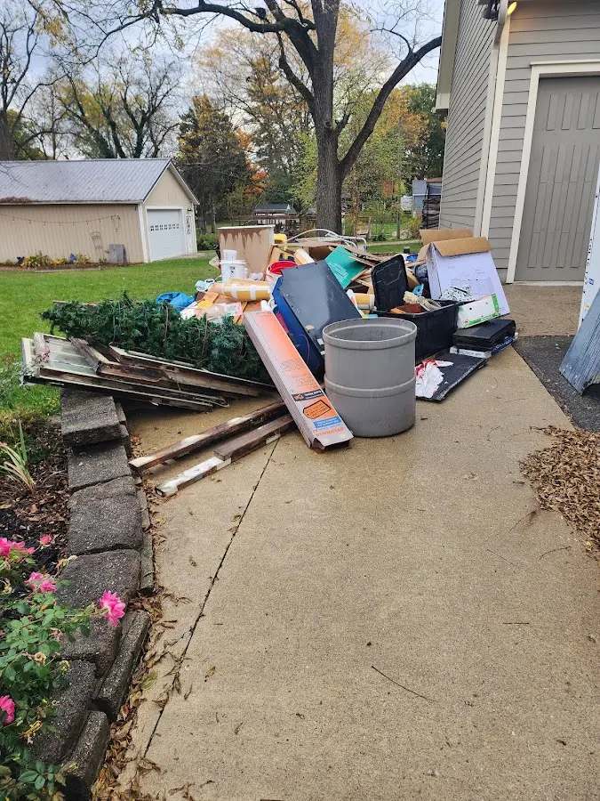Dumpster being loaded with debris for 10 Yard Dumpster Rental in Howard